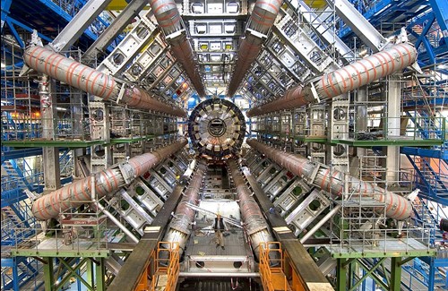 The inside of a massive scientific installation with eight pipes running to a central chamber