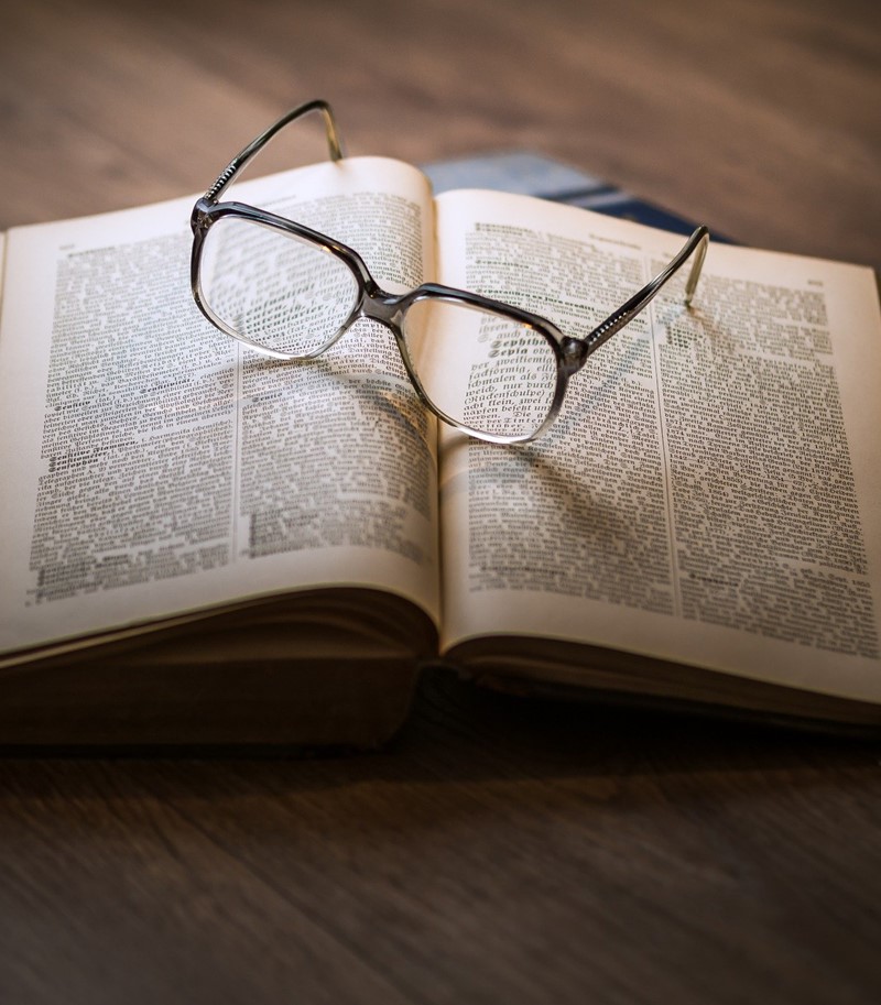 Glasses on top of open book